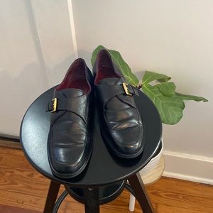 Black Etienne Aigner loafers with gold buckles